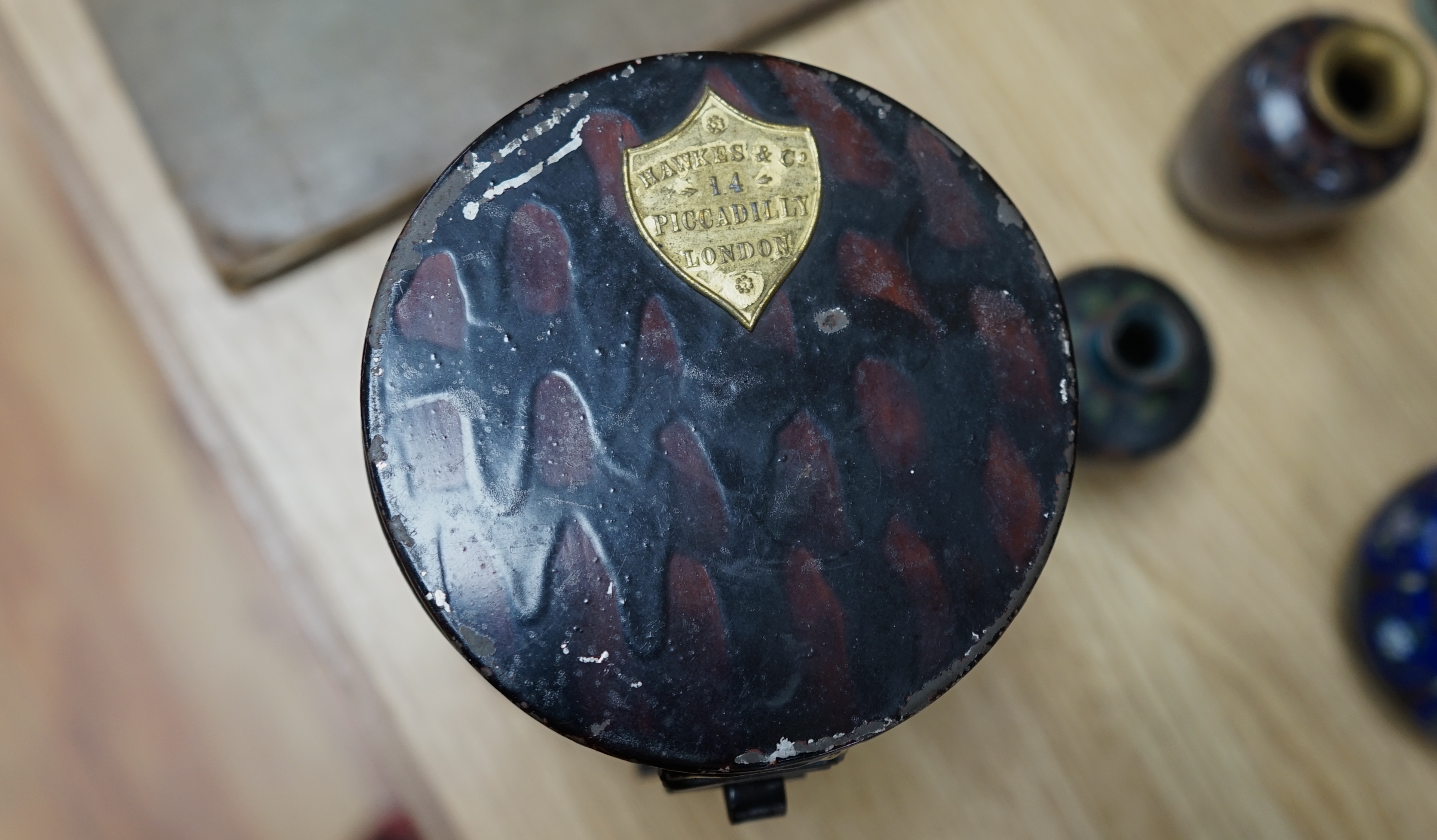 A bicorn hat and tin box, the latter inscribed C.W.Ruse, R.N, together with a black single Plume, in a double ended tin box and a red and white Plume by Hawkes of London, in a double ended tin box (3). Condition - fair t